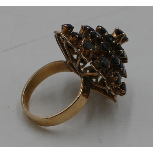 554 - A high carat gold waterfall ring set with 31 sapphires, size I/J, 6.8 grams gross.