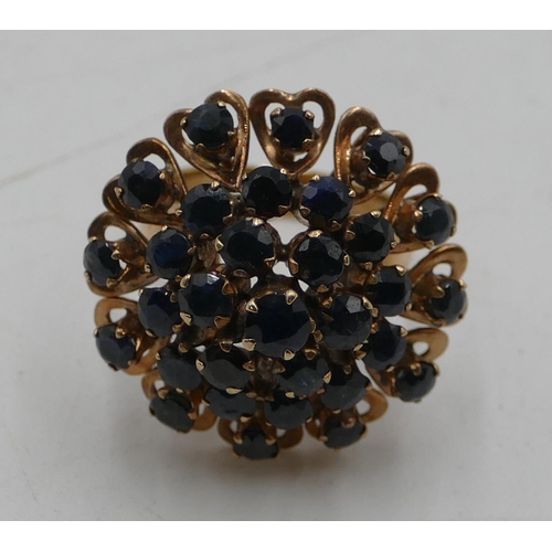 554 - A high carat gold waterfall ring set with 31 sapphires, size I/J, 6.8 grams gross.