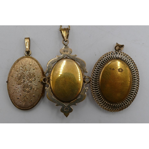 561 - A French gold-plated oval drop pendant/locket with hinged front with raised floral and leaf decorati... 