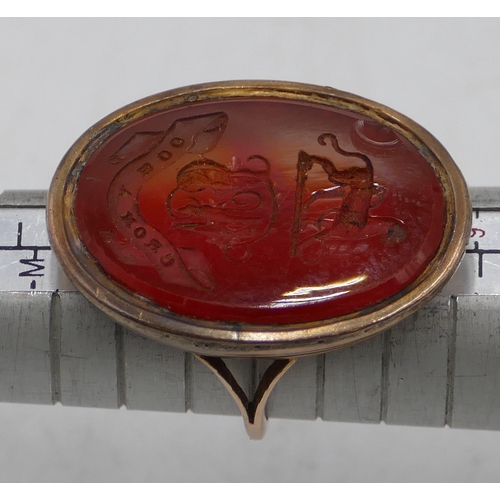 571 - A Georgian gold seal ring set with oval red seal depicting family crest (Slight chip to rim), seal 3... 