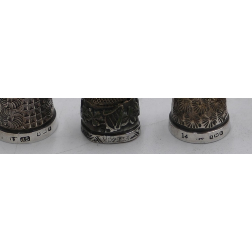 574 - 3 silver thimbles and a Treen thimble case in form of an acorn. (4)