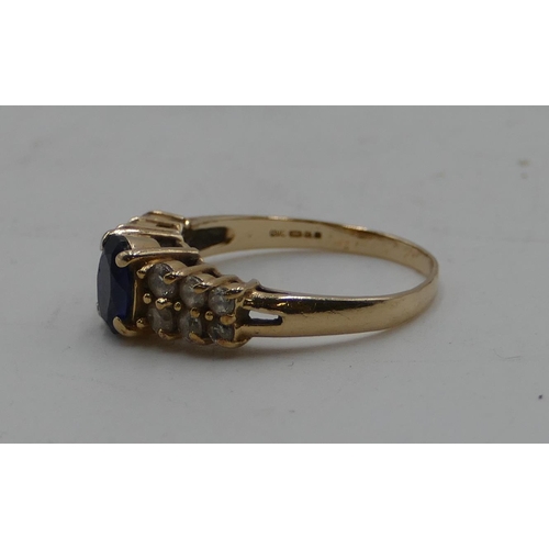 586 - A 14ct gold ladies' ring set with centre sapphire, flanked by 12 clear stones, size M/N, 2.9 grams g... 