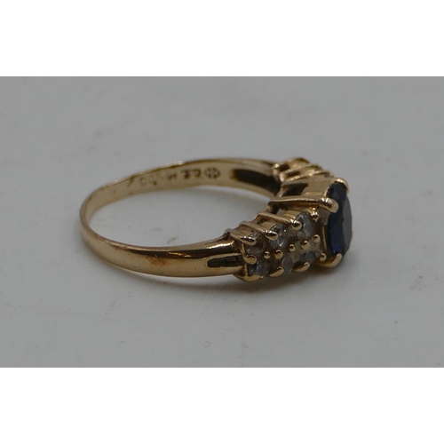 586 - A 14ct gold ladies' ring set with centre sapphire, flanked by 12 clear stones, size M/N, 2.9 grams g... 