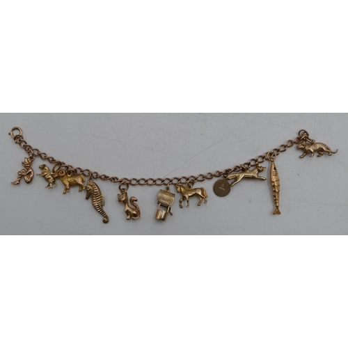 590 - A 9ct gold bracelet mounted with 11 9ct gold charms, 27.8 grams.