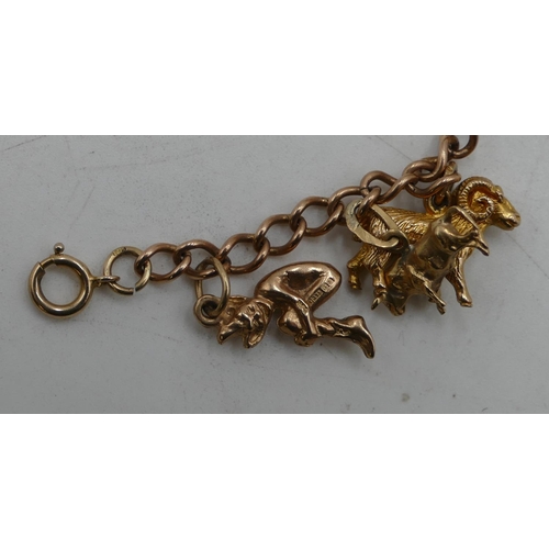 590 - A 9ct gold bracelet mounted with 11 9ct gold charms, 27.8 grams.