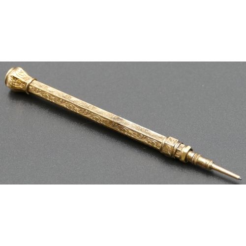 597 - A gold coloured hexagonal propelling pencil mounted with citrine and allover engraved decoration, 9.... 