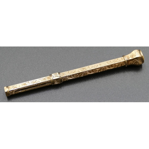 597 - A gold coloured hexagonal propelling pencil mounted with citrine and allover engraved decoration, 9.... 