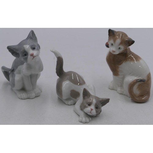 6 - 2 Lladro figures of seated and prowling cat, largest 14cm high and a Nao seated cat. 13cm high (3)