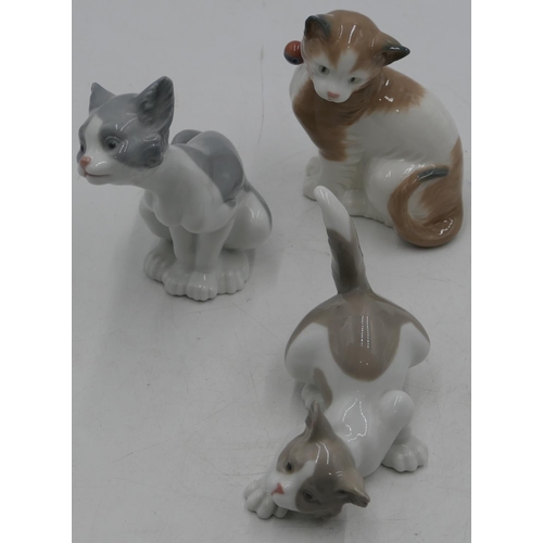 6 - 2 Lladro figures of seated and prowling cat, largest 14cm high and a Nao seated cat. 13cm high (3)