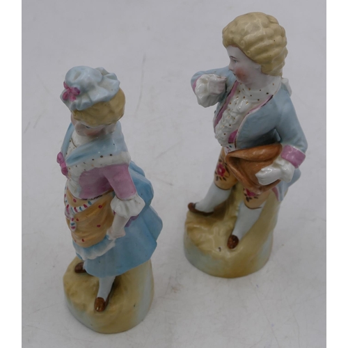 62 - A pair of Bisque china figures of young gentleman and lady, on blue and pink ground, 22cm high.