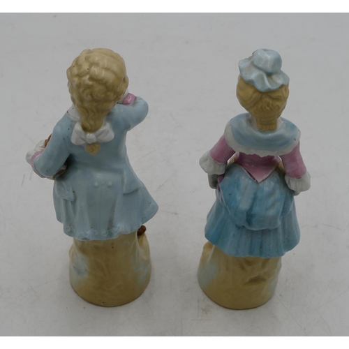 62 - A pair of Bisque china figures of young gentleman and lady, on blue and pink ground, 22cm high.