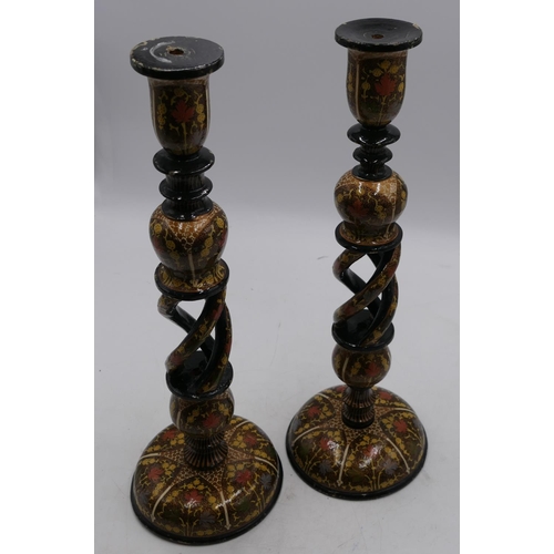 652 - A pair of Cashmere style candlesticks on turned and pierced stems with multi coloured floral, leaf a... 