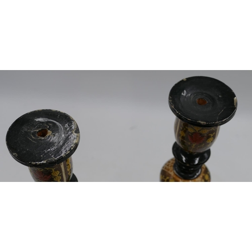 652 - A pair of Cashmere style candlesticks on turned and pierced stems with multi coloured floral, leaf a... 