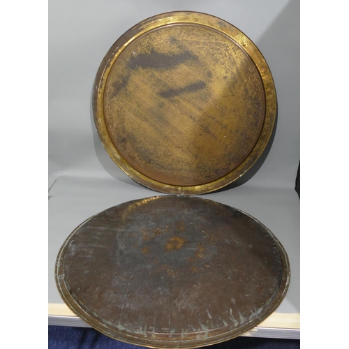 655 - 2 Arabic round brass trays with black inscription and scroll decoration, 65cm diameter and 61cm diam... 