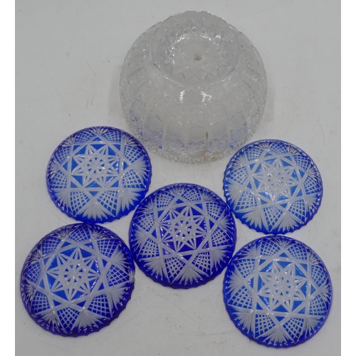 66 - A heavy cut glass round bulbous shaped fruit bowl with crinkled rim and allover tooth cut decoration... 