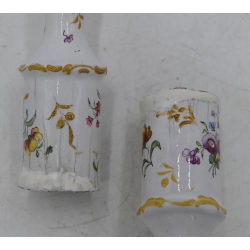 668 - A pair of 18th Century Bilston enamelled candlesticks on white grounds with multi-coloured figure, f... 