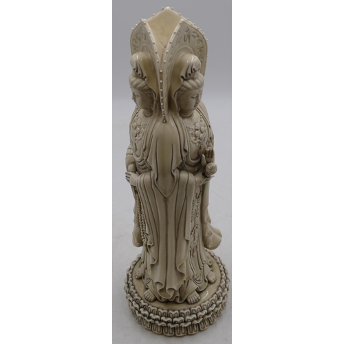 75 - A blanc de chine group of 3 standing goddesses on round base, 41cm high.