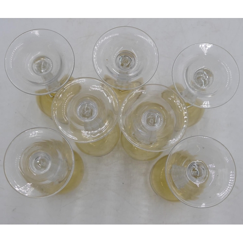 77 - A set of 7 hock glasses with amber coloured bowls on clear hexagonal stems and round bases, 18cm hig... 