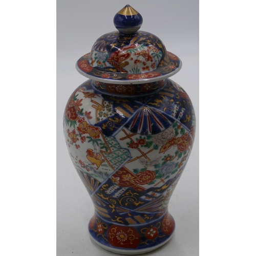 80 - An Imari round bulbous thin necked lidded vase on white, red and blue ground with allover bird, flor... 