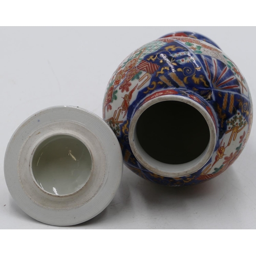 80 - An Imari round bulbous thin necked lidded vase on white, red and blue ground with allover bird, flor... 