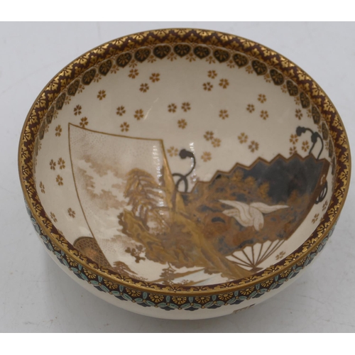 81 - A signed Meiji Satsuma bowl on cream ground with multi-coloured river, landscape, bird, fan and gilt... 