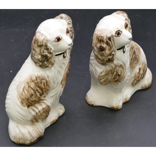 102 - A pair of 19th Century Staffordshire figures of seated spaniels with glass eyes, on white and brown ... 