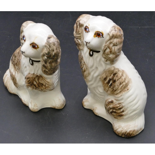 102 - A pair of 19th Century Staffordshire figures of seated spaniels with glass eyes, on white and brown ... 