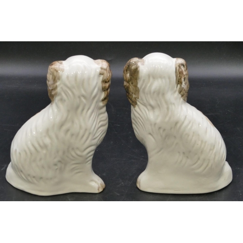 102 - A pair of 19th Century Staffordshire figures of seated spaniels with glass eyes, on white and brown ... 