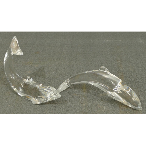 107 - 2 Baccarat clear glass models of dolphins, largest 16cm long. (2)