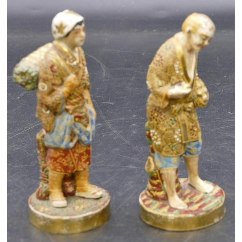 108 - A pair of Oriental Satsuma figures of standing gentleman and lady with all over raised floral, leaf ... 