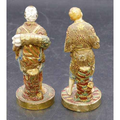 108 - A pair of Oriental Satsuma figures of standing gentleman and lady with all over raised floral, leaf ... 