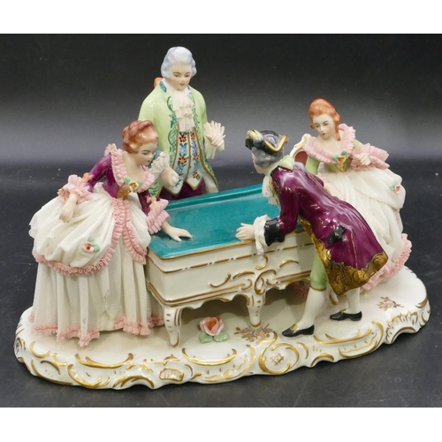 110 - A Naples porcelain group of 4 figures standing around a table, on scallop shaped base, 29.5cm long, ... 