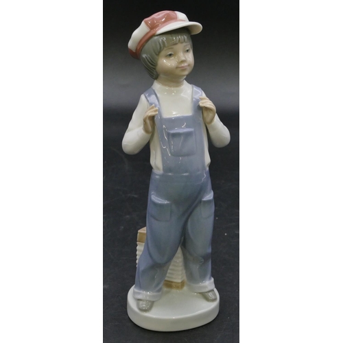 112 - A Lladro figure of a standing boy with an accordion at his feet, 22cm high.