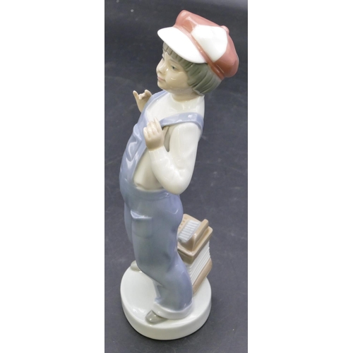 112 - A Lladro figure of a standing boy with an accordion at his feet, 22cm high.