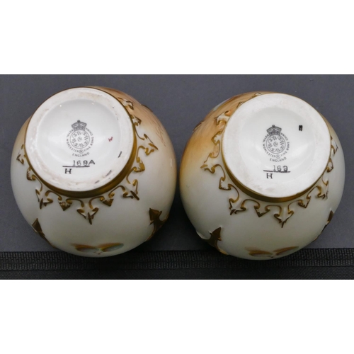 119 - A pair of Royal Worcester round bulbous thin necked lidded vases decorated by Frank Roberts on white... 