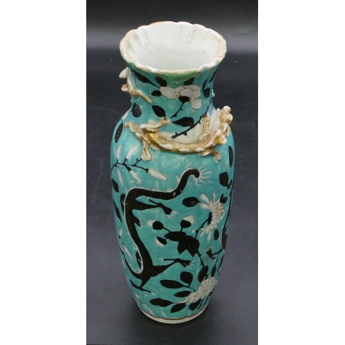 123 - An Oriental round bulbous thin necked trumpet shaped vase on turquoise ground with black and white d... 