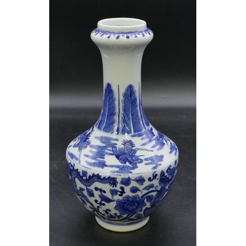 124 - An Oriental round bulbous thin necked trumpet shaped vase on blue and white ground with dragon and p... 