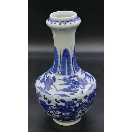 124 - An Oriental round bulbous thin necked trumpet shaped vase on blue and white ground with dragon and p... 