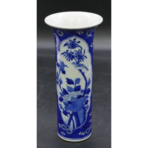 127 - An Oriental cylindrical trumpet shaped vase on blue and white ground with panels of birds, branch an... 