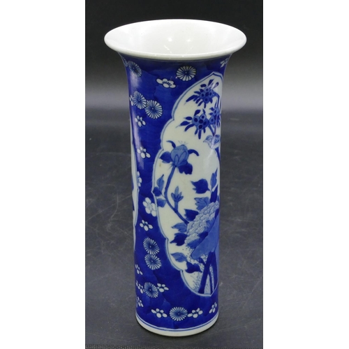 127 - An Oriental cylindrical trumpet shaped vase on blue and white ground with panels of birds, branch an... 