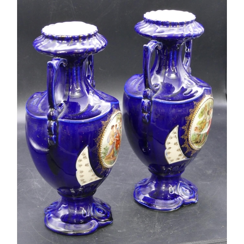 129 - A pair of round bulbous thin necked trumpet shaped 2-handled vases on royal blue ground with circula... 