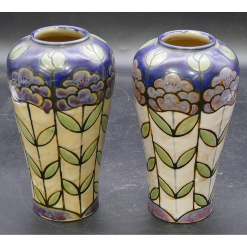 138 - A pair of Royal Doulton glazed earthenware round bulbous shaped vases on multi-coloured ground with ... 