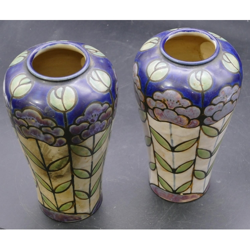 138 - A pair of Royal Doulton glazed earthenware round bulbous shaped vases on multi-coloured ground with ... 