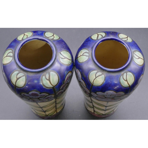 138 - A pair of Royal Doulton glazed earthenware round bulbous shaped vases on multi-coloured ground with ... 