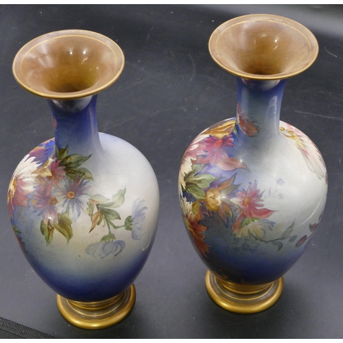 139 - A pair of Doulton & Lambeth round bulbous thin necked trumpet shaped vases on blue ground with multi... 