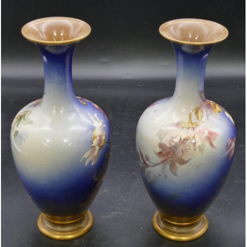 139 - A pair of Doulton & Lambeth round bulbous thin necked trumpet shaped vases on blue ground with multi... 