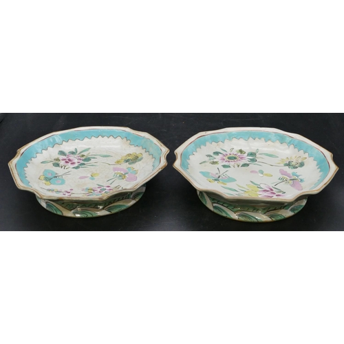 143 - A pair of Oriental round scallop shaped shallow comports on white and turquoise ground with butterfl... 