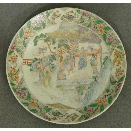 144 - A 19th Century Oriental charger with multi-coloured figure, bird, floral, leaf and scroll decoration... 