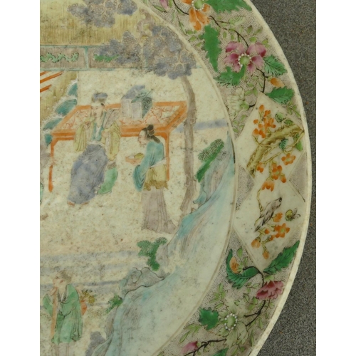 144 - A 19th Century Oriental charger with multi-coloured figure, bird, floral, leaf and scroll decoration... 