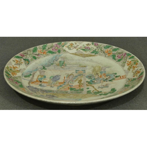 144 - A 19th Century Oriental charger with multi-coloured figure, bird, floral, leaf and scroll decoration... 